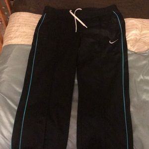 Black Nike sweats with blue lining on sides.